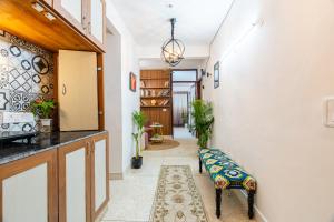 a hallway with a bench in a room at Homlee-Excellency 4BHK Apt in South Delhi in New Delhi