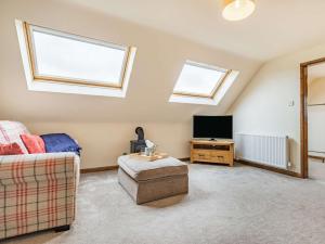 a living room with a couch and a tv at 1 Bed in Hawarden 86711 in Hawarden