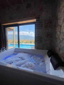 bañera con vistas a una ventana en Villa İkizler 2 / Seydikemer, en Fethiye