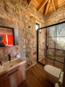 y baño de piedra con lavabo y ducha. en Villa İkizler 2 / Seydikemer, en Fethiye