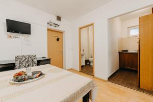 a white room with a table and a bathroom at Apartament Piata Amzei 1 (17 B) in Bucharest
