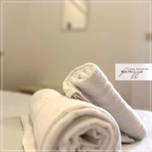 a pile of towels sitting on top of a bed at trullo a volte a stella in Alberobello +14 photos