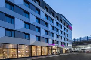 a rendering of a hotel building with a parking lot at Moxy Vienna City East in Vienna