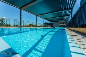 a swimming pool on the roof of a building at Baltic Apartments - Seaside Garden Apartments & Wellness in Świnoujście