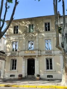 a white building with a hotel sign on it at Will's Hotel in Narbonne