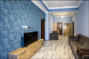 a living room with a couch and a flat screen tv at Komitas Residence in Yerevan