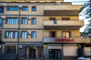 a brick building with a us online sign on it at Komitas Residence in Yerevan