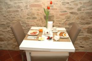 a white table with breakfast food on it at B&B La Loggia e L’Orologio in Castiglione del Lago