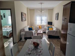 a living room with a dining table and a living room at Plateia Home in Karditsa