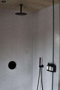 a bathroom with a shower with white tiled walls at Hilltop Forest in Inkoo