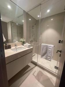 a bathroom with a shower and a sink and a mirror at 2 Bedrooms Apartment Burj khalifa and fountain view in Dubai