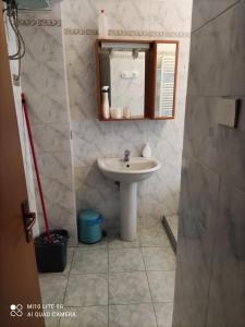 bagno con lavandino e specchio di HOSTAL D'ANNUNZIO HOUSe a Cesano Boscone