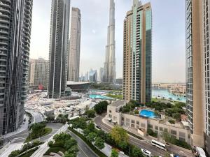 an aerial view of a city with tall buildings at Burj khalifa and fountain view 2bedrooms in Dubai
