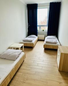 a room with three beds and a window at StarBal in Radom