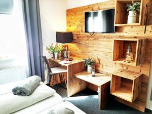 a room with a wooden wall with a desk at Hotel Goldene Steig in Kempten