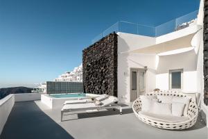 a villa with a swimming pool on the roof at Grace Hotel, Auberge Resorts Collection in Imerovigli