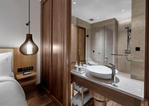 a bathroom with a sink and a shower at Holiday Inn Resort Bali Canggu by IHG in Canggu