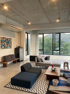 a living room with a couch and a table at ATATvilla Khaoyai with mountain rooftop view for party and BBQ in Mu Si