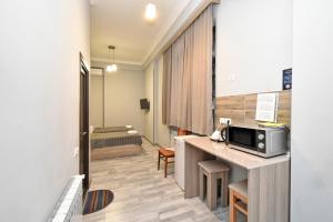 a hotel room with a kitchen and a bed at Komitas Residence in Yerevan +152 photos