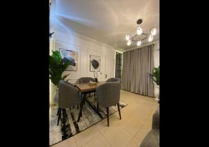a dining room with a table and chairs at Exquisite Lekki Phase1 Apartment in Lagos