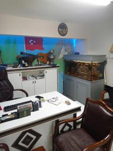 a room with a desk and a fish tank at Sahin Home Office in Istanbul