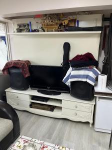 a white dresser with a tv on top of it at Sahin Home Office in Istanbul