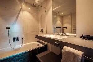 a bathroom with a tub and a sink and a shower at Chalet with a beautiful view on the heights of in Verbier