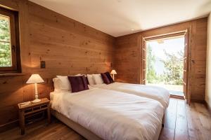 a bedroom with a large bed and a window at Chalet with a beautiful view on the heights of in Verbier