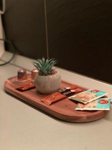a wooden cutting board with a potted plant on it at Federal Luxury in Drobeta-Turnu Severin