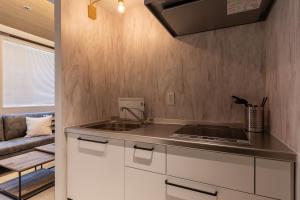 a kitchen with a sink and a counter top at 松山大街道HOTELさくら- unmanned hotel - in Matsuyama