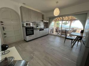 a kitchen with a table and a dining room at Villa Les Issambres, 4 pièces, 7 personnes - FR-1-632-4 in Les Issambres