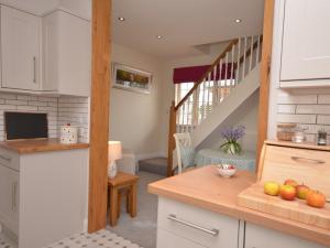 uma cozinha com armários brancos e uma escadaria em 1 Bed in Street 60555 em Walton