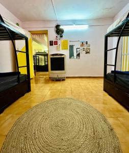 a room with two bunk beds and a rug at Endless Blue Hostel 