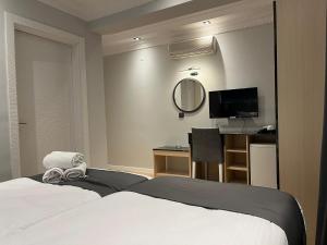a bedroom with a bed and a desk and a mirror at ARDOS PARK HOTEL in Ankara