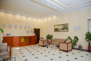 a hospital waiting room with chairs and a table at Majestic Palace Hotel in Samarkand