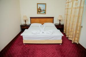 Ένα ή περισσότερα κρεβάτια σε δωμάτιο στο Majestic Palace Hotel