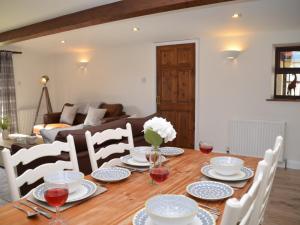 a dining room table with plates and wine glasses on it at 2 Bed in Bath 56550 in Stowey