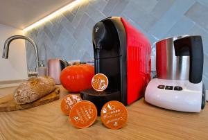 a kitchen counter with a red toaster and some bread at Slow River Apartment in Nowe Miasto Lubawskie