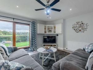 a living room with a couch and a table at 2 Bed in Northwich 85877 in Kingsley