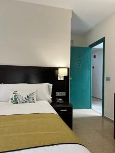a bedroom with a large bed and a blue door at Itaca Colón by Soho Boutique in Córdoba