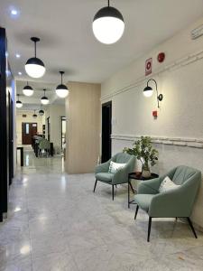 a lobby with chairs and tables in a building at Itaca Colón by Soho Boutique in Córdoba