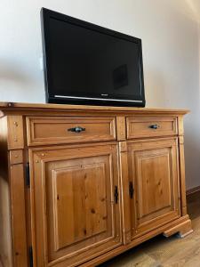 a television on top of a wooden dresser at Penzion LaCasa in Vysoké Mýto
