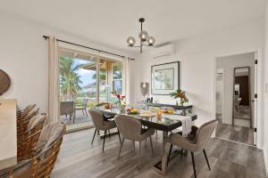 a dining room with a black table and chairs at Aloha Breeze by AvantStay Ocean View Near Beach in Waianae