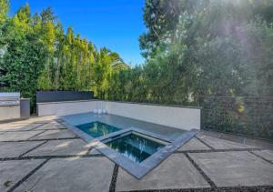 a swimming pool in the middle of a patio at Contemporary 4 Bedroom Villa In West Hollywood in Los Angeles