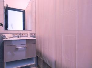 a pink bathroom with a sink and a mirror at rabatapartmentresidence in Rabat
