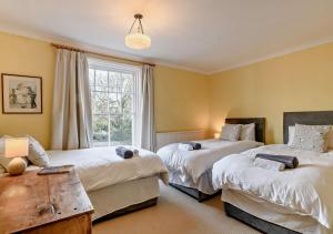 a bedroom with two beds and a window at Bond Cottage in Overstrand