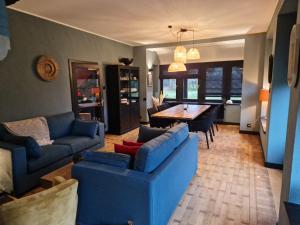 uma sala de estar com um sofá azul e uma mesa em Villa Simone em Spa