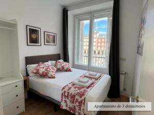 a bedroom with a bed and a large window at Plaza Mayor in Madrid