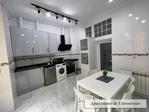 a kitchen with a white table and a white table and chairs at Plaza Mayor in Madrid