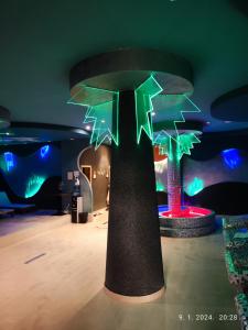 a room with a tree with lights on it at Castello apartman Kopaonik Kraljevi Cardaci komplex in Kopaonik +31 photos